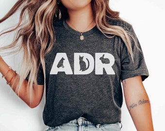 May include: A dark grey heather t-shirt with the letters "ADR" in white, each letter containing a silhouette of a dog, cat, and rabbit.