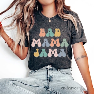 May include: A gray t-shirt with the text "Bad Mama Jama" in colorful, retro-style letters.