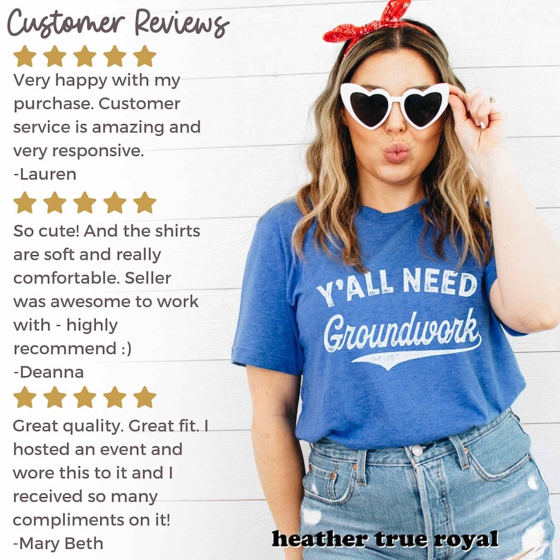 May include: A blue t-shirt with the text "Y'ALL NEED GROUNDWORK" in white. The shirt is being worn by a person with long blonde hair and heart-shaped sunglasses. The person is smiling and looking at the camera. The text "heather true royal" is visible at the bottom of the image.