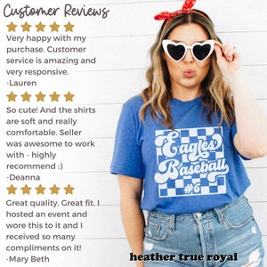 May include: A blue t-shirt with a white and blue checkered design that says "Eagles Baseball #6". The shirt is heather true royal. The image also includes customer reviews.