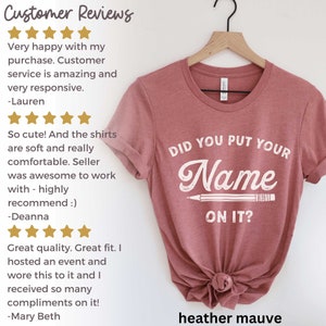 May include: Heather mauve t-shirt with the text "Did you put your name on it?" in white lettering with a pencil graphic.