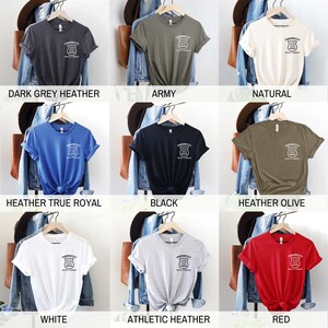 May include: A collection of t-shirts in various colors, including dark grey heather, army, natural, heather true royal, black, heather olive, white, athletic heather, and red. Each shirt features a white graphic of a shield with the text "Thundercat Police" and "Protect & Serve" inside.