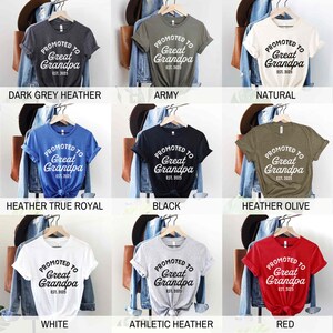 May include: Nine different t-shirts in various colors, each with the text "PROMOTED TO Great Grandpa EST. 2025". Colors include dark grey heather, army green, natural, heather true royal, black, heather olive, white, athletic heather, and red.
