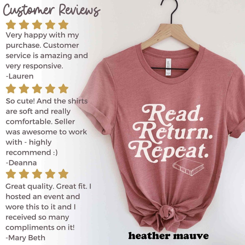 May include: A heather mauve t-shirt with the words "Read. Return. Repeat." in white script, along with a small book illustration. The shirt is displayed on a hanger.
