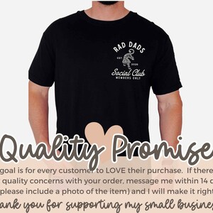 May include: Black t-shirt with a white graphic design that says "Rad Dads Social Club Members Only" with a tiger illustration. The text "Est. 2025" is also included in the design.