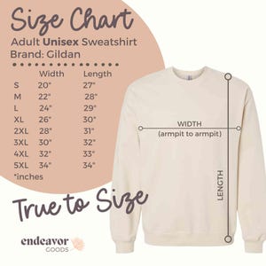 May include: Size chart for an adult unisex sweatshirt, showing width and length measurements in inches for sizes S through 5XL. The brand is Gildan. The chart is on a pink background with a white outline. The chart is next to a beige sweatshirt with the words "True to Size" printed below it.