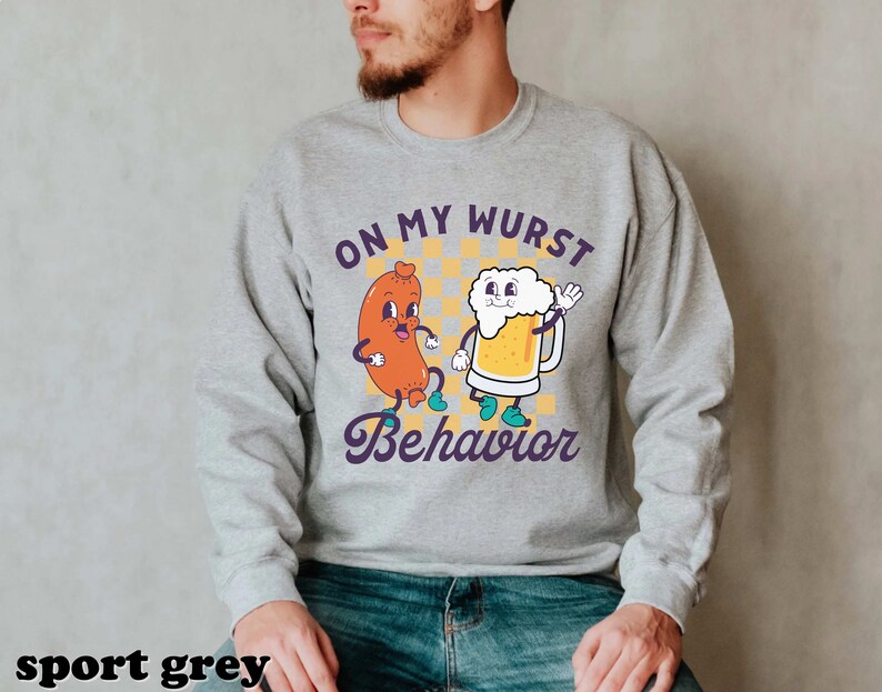 May include: A gray sweatshirt with a cartoon sausage and beer design. The text on the sweatshirt reads "On My Wurst Behavior".