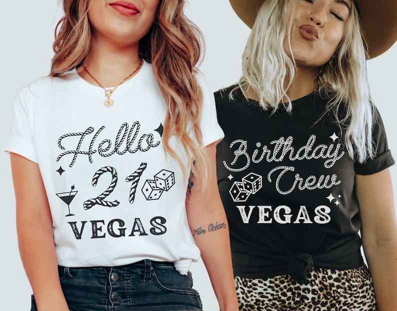 May include: Two women wearing matching t-shirts with a Vegas birthday theme. The white shirt says "Hello 21 Vegas" with a rope design, dice, and a martini glass. The black shirt says "Birthday Crew Vegas" with a rope design and dice.