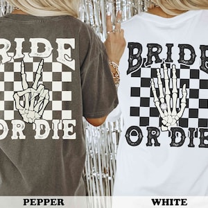 May include: Two gray and white t-shirts with a checkered background and a skeleton hand. One shirt says "Ride or Die" and the other says "Bride or Die".