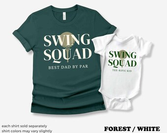 May include: Forest green t-shirt with white text that says "Swing Squad Best Dad By Par" and a golf ball graphic. White baby bodysuit with white text that says "Swing Squad Tee-Rific Kid" and a golf ball graphic.