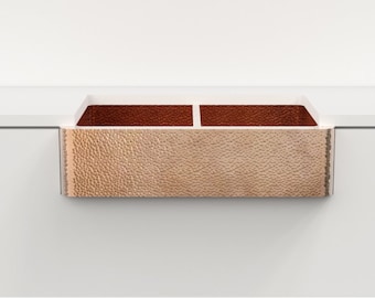 May include: A hammered copper kitchen sink with two basins. The sink is installed in a white countertop.