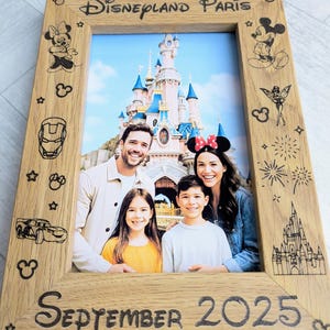 May include: Wooden photo frame with "Disneyland Paris" and "September 2025" text. The frame features Disney character illustrations and a family photo in front of a castle.