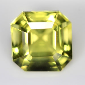 May include: A light green gemstone with a square emerald cut.