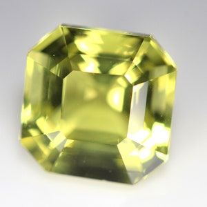 May include: A light green gemstone with a square emerald cut.