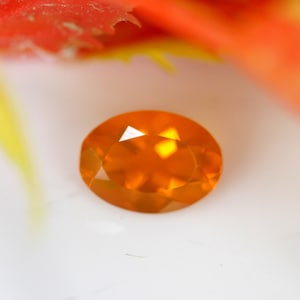 0.51 Carats! Natural Mexican Fire Opal Faceted. 7x5 MM Oval Shape. Orange Color. Calibrated Size. Loose Gemstone.