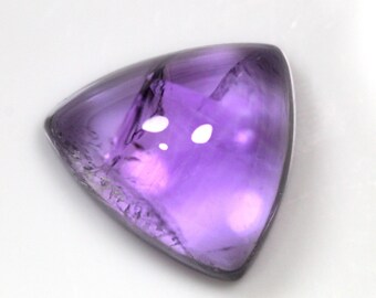 May include: A triangular, purple amethyst gemstone with a faceted cut. The gemstone has a light purple hue and is translucent.