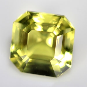 May include: A light green gemstone with a square emerald cut.