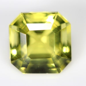 May include: A light green gemstone with a square emerald cut.