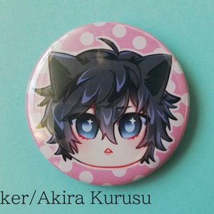 May include: A pink and white polka dot button featuring a cartoon character with black hair, blue eyes, and cat ears. The character's name is "Joker/Akira Kurusu".