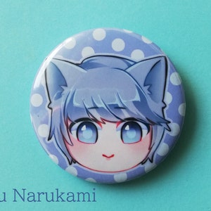 May include: A blue and white polka dot button featuring a cartoon character with blue hair, blue eyes, and cat ears. The character's name is "Yu Narukami".