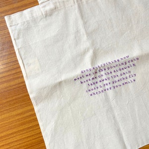 Handmade calligraphy embroidered tote bag inspired by Sparks Fly SN