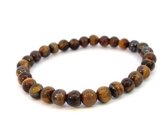May include: A brown and gold beaded bracelet made of tiger's eye stones.