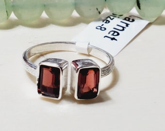 May include: A silver ring with two rectangular garnet stones. The ring is size 8.