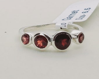 Può includere: Un anello d'argento con quattro pietre di granato rosso. L'anello è taglia 6,5.