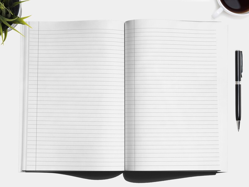 May include: An open lined notebook with a black pen lying on a white surface.