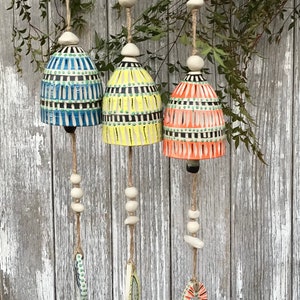 Brightly coloured, carved, Pottery Bell, wind chime , fun and happy garden art.