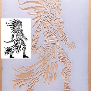 May include: A rectangular stencil featuring a laser-cut design of a warrior in a headdress holding a curved blade. The stencil is translucent with a brown label in the corner that reads Durable LASER CUT Mylar. A black graphic shows the design.