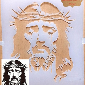 May include: White stencil of a man's face with a crown of thorns on his head. The stencil is on a wooden background. The text "Durable LASER CUT Mylar" is in a brown rectangle in the upper right corner of the image.