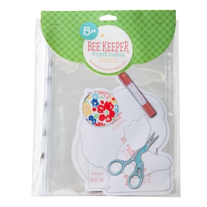May include: A pack of five Bee Keeper Pocket Inserts, a sewing craft supply. The package includes five white paper templates with different shapes, a red and white floral fabric circle, a red crayon, and a pair of blue scissors.
