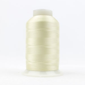 May include: A spool of off-white thread for sewing or embroidery.