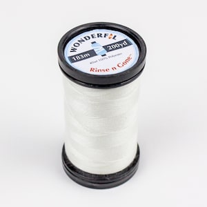 May include: White thread spool labeled "Wonderful" with "183m 200yd 40wt 100% Polyester Rinse n Gone"