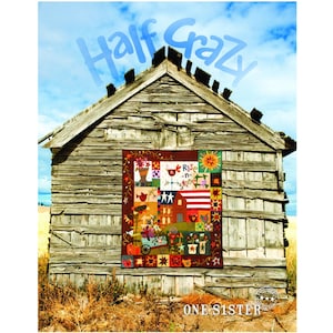 May include: A colorful quilt with a patchwork design, featuring various patterns and images, including a sun, birds, and stars, hangs on a weathered wooden structure. The words "Half Crazy" are written across the top in blue, with the words "Rise -n- Shine" on the quilt.