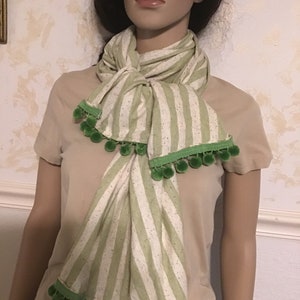 Brand New  Scarf  With Green/Beige Stripes ,Specs of Red/Blue Throughout.  Large Size 68”x 23” Light Green Pom Pom Fringe.Beautiful Scarf.