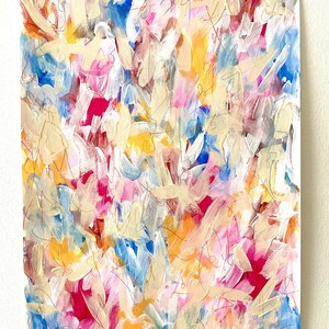 May include: Abstract painting with a colorful, layered, and textured style. The painting features a mix of pink, blue, yellow, and white paint strokes.