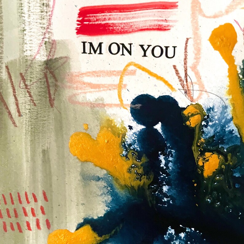 May include: Abstract painting with splashes of yellow, blue and black paint. The text "IM ON YOU" is written in black on a white background.