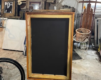 Repurposed side walk sign made of old wooden ladder and window frames.