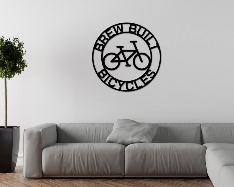 May include: Black metal sign with the text "Brew Built Bicycles" in a circle with a bicycle silhouette inside.