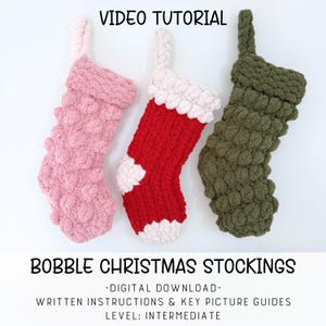 May include: Three crocheted Christmas stockings with bobble texture. One is light pink, one is red with white cuff, heel, and toe, and one is olive green. Text reads: VIDEO TUTORIAL BOBBLE CHRISTMAS STOCKINGS DIGITAL DOWNLOAD WRITTEN INSTRUCTIONS & KEY PICTURE GUIDES LEVEL: INTERMEDIATE