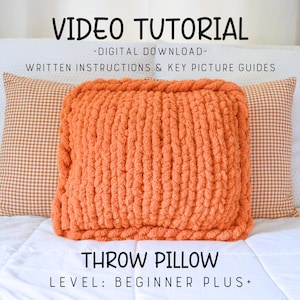 May include: An orange throw pillow made with chunky yarn, centered on a white bed. The pillow is square and has a textured appearance. The text "VIDEO TUTORIAL" and "THROW PILLOW" are displayed. The level is "BEGINNER PLUS+".
