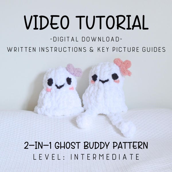 May include: Two white crochet ghost figures with black eyes, smiles, and pink blush. One ghost has a pink bow, the other a pink heart. The image includes the text "VIDEO TUTORIAL" and "2-IN-1 GHOST BUDDY PATTERN".
