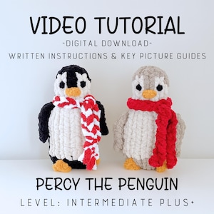 May include: Two plush penguin toys, one black and white, the other gray and white, each wearing a scarf. The black and white penguin has a red and white scarf. The gray and white penguin has a red scarf. Text at the top reads "VIDEO TUTORIAL".