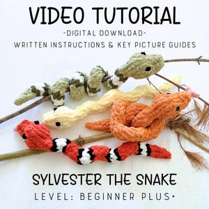 May include: Three crocheted snakes in green, yellow, and orange with black eyes, featuring text: VIDEO TUTORIAL -DIGITAL DOWNLOAD- WRITTEN INSTRUCTIONS & KEY PICTURE GUIDES SYLVESTER THE SNAKE LEVEL: BEGINNER PLUS+. The snakes are coiled around wooden branches.
