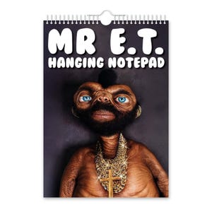 May include: A hanging notepad featuring a humorous image of a character resembling E.T. with a mohawk, beard, and gold chain. The notepad has a spiral binding at the top and the text "MR E.T. HANGING NOTEPAD" in white letters.