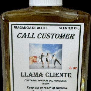 May include: A small, clear glass bottle of scented oil with a white cap. The label reads "CALL CUSTOMER" and "LLAMA CLIENTE" with a small image of people. The bottle contains 1 fl oz of oil.