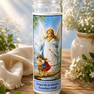 May include: A clear glass prayer candle featuring a label with an illustration of a guardian angel watching over two children crossing a wooden bridge. The label includes the text "Ángel de la Guarda" and "Guardian Angel" in blue and black lettering.