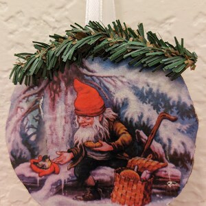 Scandinavian Santa Tomte in the Forest feeding the birds.